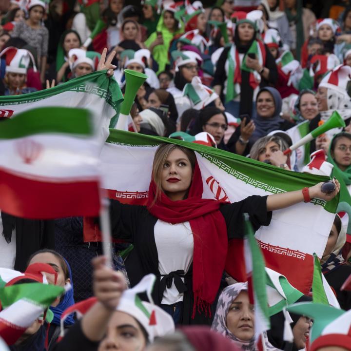 Iranian women display their national flag at a soccer game - source: Reuters