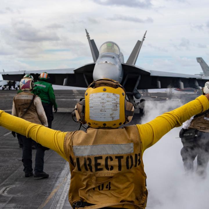 Flight deck crew issues commands to a U.S. Navy F/A-18 Super Hornet prior to launch from the carrier USS Harry S. Truman - source: Department of Defense