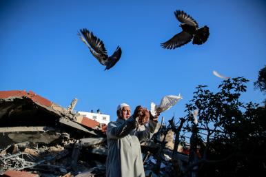 A Palestinian man in Gaza releases pigeons