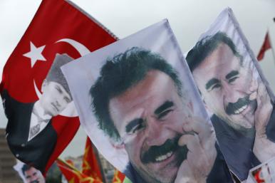 Demonstrators fly a mixture of Turkish flages featuring the image of the Republic of Turkey's founder, Kemal Mustafa Ataturk, and banners depicting Kurdish militia leader Abdullah Ocalan - source: Reuters
